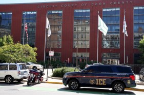 A U.S. Immigration and Customs Enforcement agent inside an ICE vehicle sits outside Domestic Violence Court on West Harrison Street in Chicago on Sept. 15, 2025. (Antonio Perez/Chicago Tribune)
